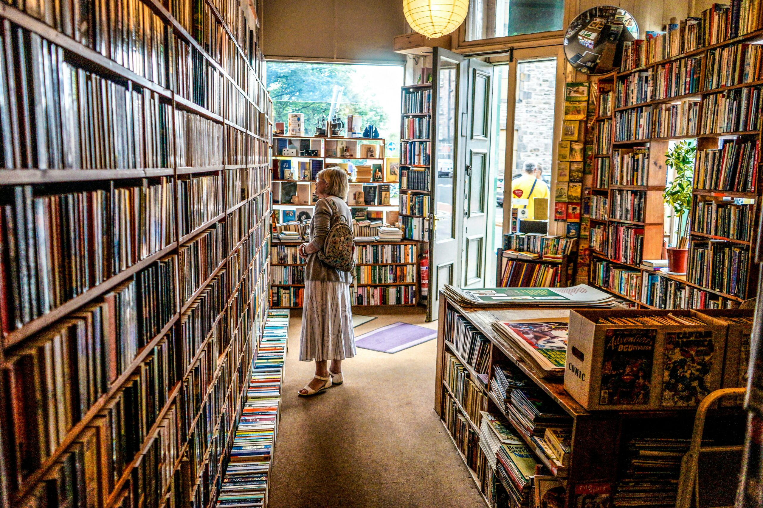 woman inside library looking at books